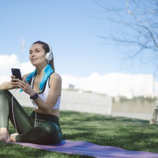 Women starting a yoga routine wearing the best earphones for yoga
